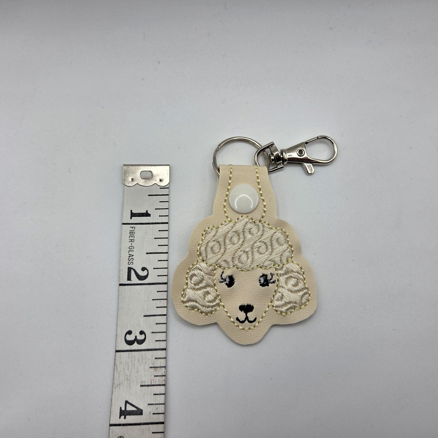 Poodle Head Keychain – Cream Embroidered Snap Tab