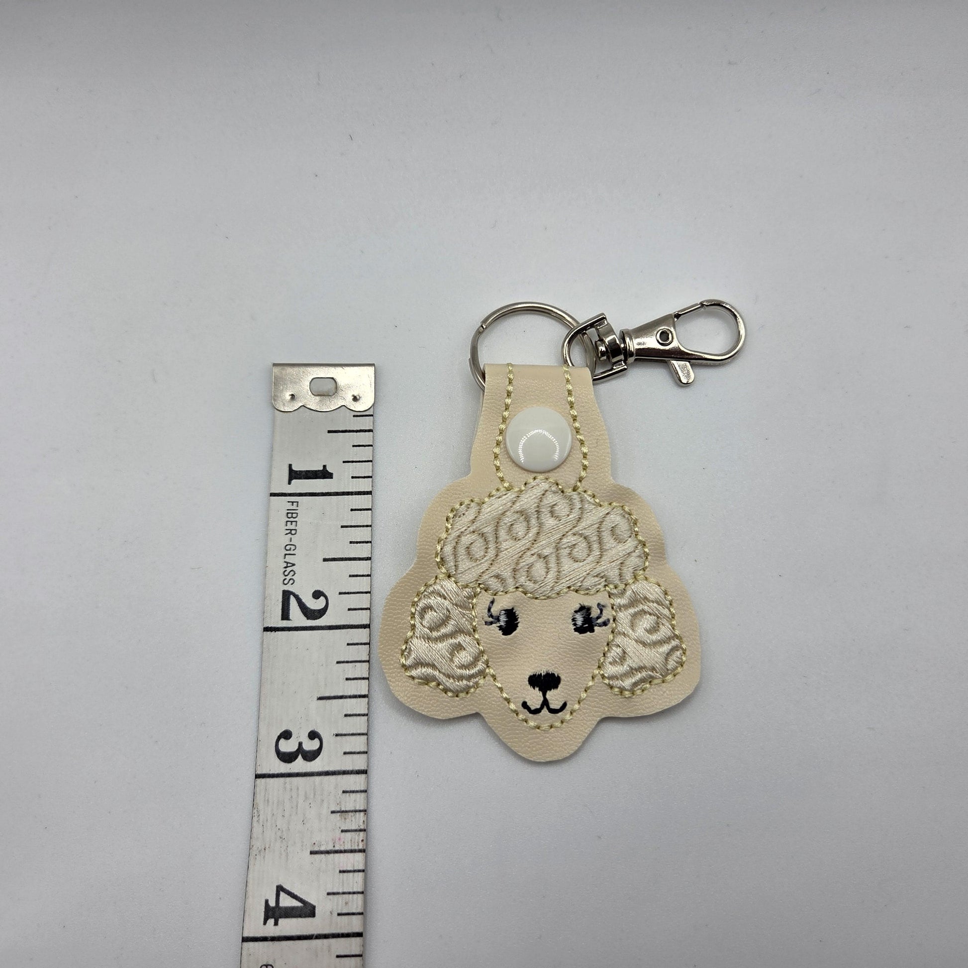 Poodle Head Keychain – Cream Embroidered Snap Tab